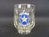 a glass with a blue star on it on a table