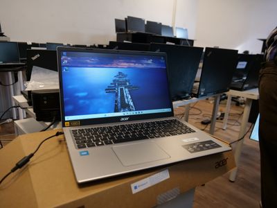 a laptop computer sitting on top of a box in a room