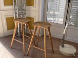 two wooden stools in the corner of a room