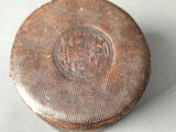 a small metal box that has a lion on it