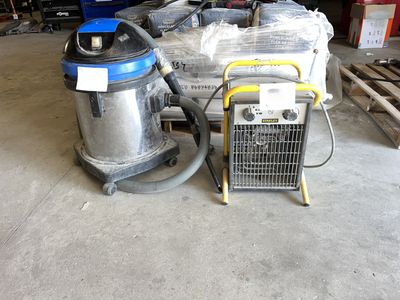 two vacuums that are sitting in a garage