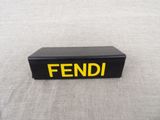 a black box with a yellow and black word on it
