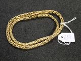 a close up of a gold chain with a tag on it