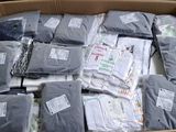 a cardboard box filled with lots of shirts and ties