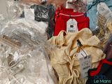 many bags of clothes and bags of clothing on the table