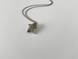 a white plate topped with a silver necklace and a starfish charm