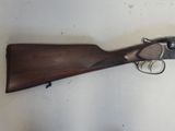 a close up of a gun on a table with a white background