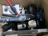 a cardboard box filled with assorted items and tools