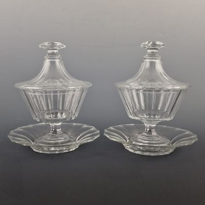 pair of clear glass salt and pepper shakers on a saucer