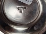 a silver plate with a price tag on it