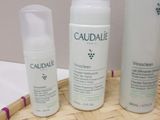 three bottles of caudale and a tube of lotion on the table