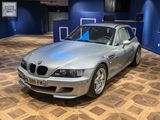 a silver car that is parked in a showroom