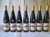 six bottles of wine are lined up on a table