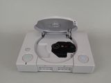a white nintendo wii game system with a remote in it