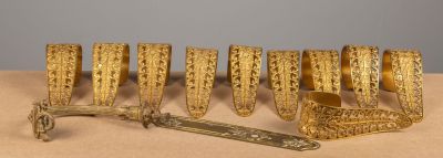 several pieces of gold are arranged in a row on a table