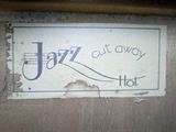 a sign that says jazz out away hot on the door