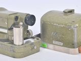 two old cameras sitting next to each other on a white surface