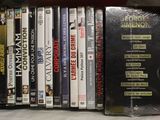 a lot of dvds in a bag on the shelf