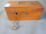 a small wooden box with a key on it