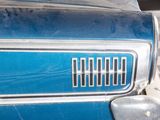 a close up of a blue car with a checkered floor