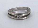 a close up of a ring with a diamond on it