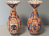 two vases that are sitting on a table
