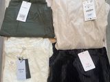 three pieces of clothing sitting on top of a wooden box