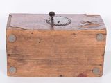 an old wooden box sitting on top of a white surface