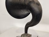 an old fashioned black gramphone on a white surface