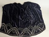 a black velvet top with beading on the neck and shoulders