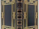 an old black book with gold trimming and a gold border
