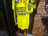 a mannequin with a yellow and black shirt on it