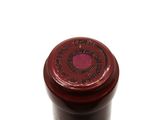 a close up of a bottle of wine on a white surface