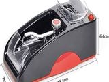 an image of a black and red sewing machine with a red handle