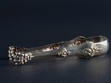 a silver spoon with a bunch of grapes on it