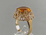 an image of a gold ring with a large citrine stone in the center