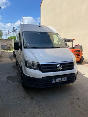 the white van is parked on the side of the road