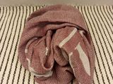 a towel on a bed with a striped blanket