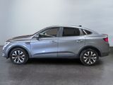 a silver suv parked in a garage with a white wall behind it