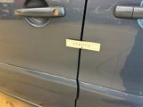 a close up of a car door handle with a sticker on it