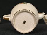 a close up of a white cup on a black surface