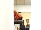 a mirror on a stand in a room with a chair