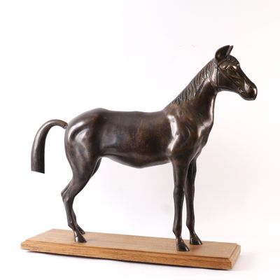 bronze statue of a horse on a wooden base on a white background