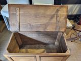 a wooden chest that is open and sitting on the floor