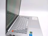 a silver laptop computer sitting on top of a white table