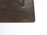 a small metal object with a cross on it