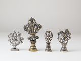 a set of four silver and gold metal figurines
