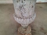 a white vase with rust on it in a room
