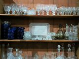 une étagère en bois remplie de verreries et de vases