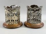 pair of antique silver and copper candle holders on wooden bases